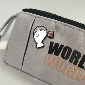 Gray canvas zipper bag with cartoon seal enamel pin and bold WORLD text design