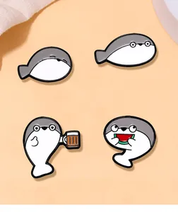 Detailed view of four cute enamel pins featuring funny sea creature facial expressions