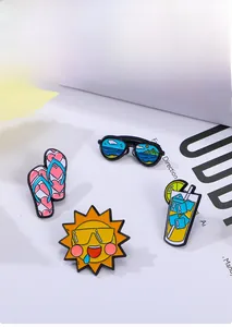 Close-up of summer themed enamel pins featuring sunglasses, flip-flops, and sun motifs