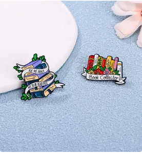 Detail of Book Collector and TBR Pile enamel pins with floral and ribbon designs