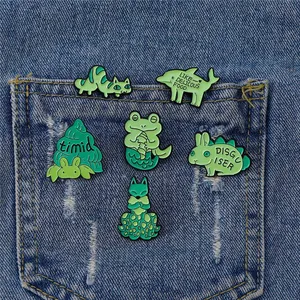 Creative green enamel pins set featuring cartoon animals on denim pocket