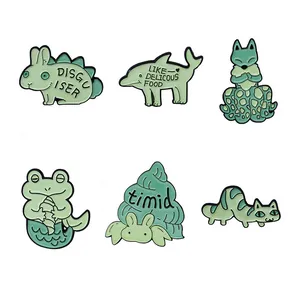 Set of 6 green enamel pins featuring unique animals like rabbit, dolphin, and frog