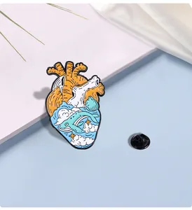 Detailed enamel heart pin featuring whale and ocean waves in Van Gogh painting style