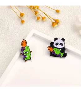 Macro detail of cartoon panda enamel brooches and colorful craft knife pins on white tray
