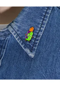 Close-up of a colorful panda cutter enamel pin attached to a blue denim jacket collar