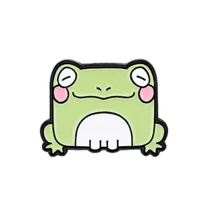 Cute green cartoon frog enamel pin badge with a smiling face on white background