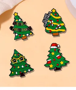 Detail of four colorful enamel Christmas tree brooches with festive holiday slogans