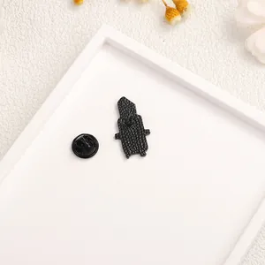 Panda knife enamel brooch showing the metal back texture and rubber clutch attachment