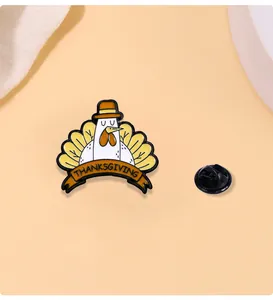 Detail view of Thanksgiving turkey enamel pin with orange banner and rubber backing