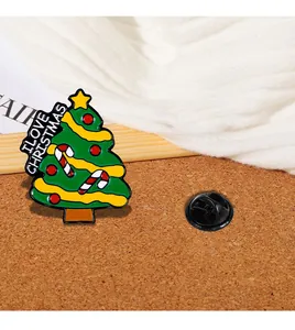 Macro view of Christmas tree enamel pin with I LOVE CHRISTMAS lettering and butterfly clutch