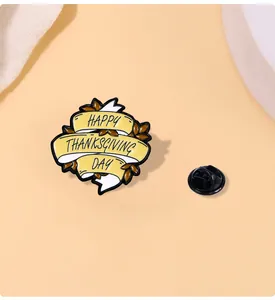 Detail of Happy Thanksgiving Day enamel pin with orange leaves and rubber clasp back