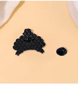 Close-up of the black enamel brooch back featuring anti-slip texture and butterfly clasp