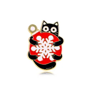 Cute black cat enamel pin holding a red Christmas snowflake ball for clothing decor