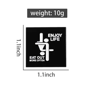 Square enamel brooch pin with black background and white text, 1.1x1.1 inch size detail