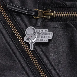 Macro detail of dolphin enamel pin on leather jacket with training porpoises text