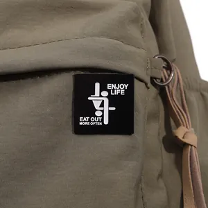 Detail of olive green canvas bag showing durable fabric and Enjoy Life slogan patch