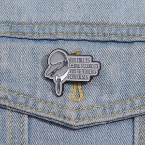 Funny dolphin enamel pin with office humor pun on light blue denim jacket