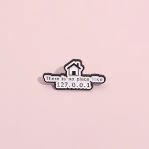Detailed view of Geek themed enamel pin with There is no place like 127.0.0.1 text