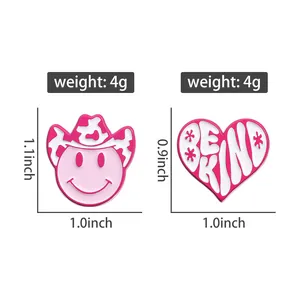 Detail of pink enamel heart and cowgirl hat lapel pins with Be Kind text and 4g weight