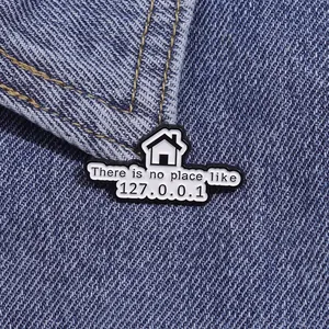 Macro shot of geek enamel pin saying There is no place like 127.0.0.1 on denim