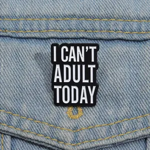Detail of I CAN'T ADULT TODAY enamel pin badge pinned on a blue denim jacket pocket