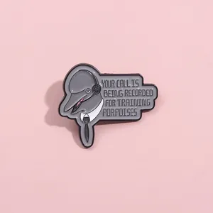 Funny dolphin customer service enamel pin with humorous text on a soft pink background
