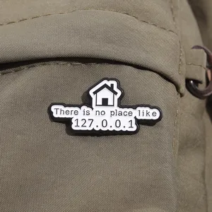 Detail of 127.0.0.1 computer joke enamel pin on textured canvas background