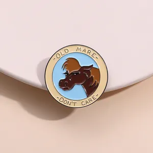 Detailed macro of a round enamel pin featuring a horse and Old Mare Don't Care text