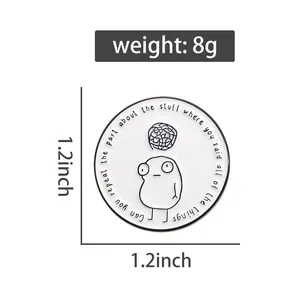 Detail view of 1.2 inch round enamel pin featuring cartoon figure and gray tangle pattern