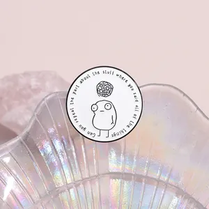 Detail of round enamel pin with quote Can you repeat the part about the stuff on a dish