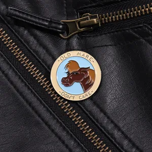 Detail of round horse head enamel pin on black leather jacket with Old Mare text