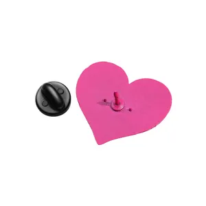 Detailed back view of pink heart enamel pin with a black rubber clutch and metal needle