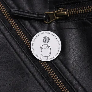 Enamel lapel pin with minimalist cartoon character on a black leather jacket