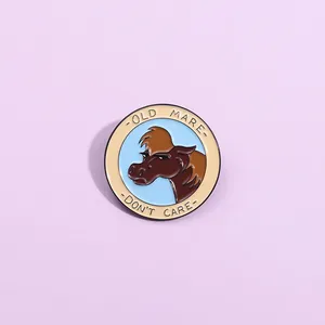 Enamel lapel pin with Old Mare Don't Care slogan and horse motif on purple background
