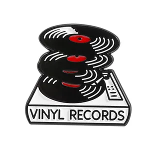 Enamel vinyl records pin with white turntable base and stack of black records