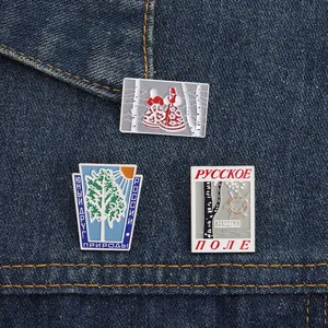 Set of 3 Russian birch tree enamel pins featuring traditional folk art on denim jacket