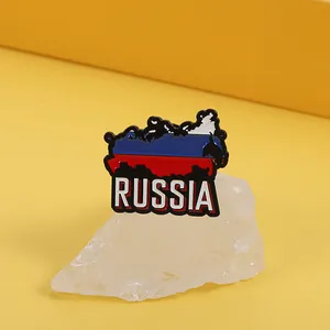 Close-up of Russia map flag enamel pin with metallic edges on decorative white crystals