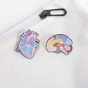 Detailed anatomy pins set with colorful brain and heart shapes on a white canvas bag