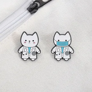 Close-up of cute white cat doctor enamel pins with stethoscope and blue medical mask