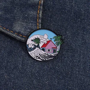 Detailed close-up of a Great Wave and pink house enamel pin on blue denim fabric