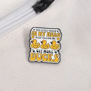 Detail of yellow duck enamel pin with humorous text on white canvas texture