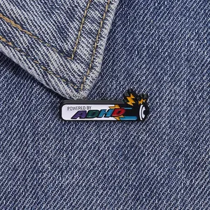 Macro shot of colorful enamel pin with Powered by ADHD text on dark denim fabric