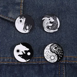 Set of four black and white Yin Yang enamel pins with cat, koi, wolf and moon on denim