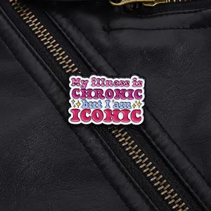 Macro shot of colorful enamel pin badge on leather jacket with iconic quote detail