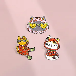 Three cute cartoon cat enamel pins set featuring floral patterns and sunglasses decor