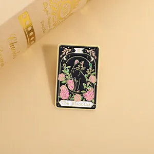 Detail of tarot card enamel pin featuring a black cat, pink roses, and golden III text