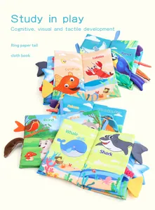 Detail view of colorful baby cloth books with textured animal tails and ring paper