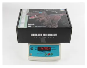 Remote control T-Rex building kit packaging on digital scale showing gross weight