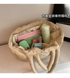 Spacious interior of beige puffer tote showing organized daily essentials and compartments