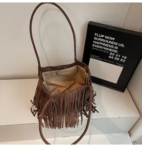 Close-up of brown suede fringe tote with magnetic closure and inner zipper pocket